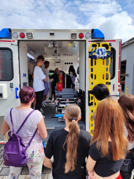 SchülerInnen vor Krankenwagen der für Krankentransport vorbereitet wird